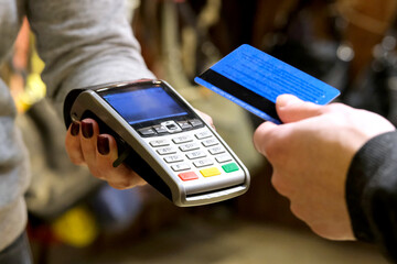 Payment by card, in the payment terminal. Electronic money. Mobile banking. Shopping complex.