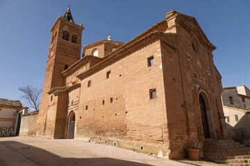 Fototapeta na wymiar Photograph of the bell tower and the church of Our Lady of the Rosary, of baroque mudejar architecture style, in the small town of Ambel, in the Campo de Borja region, Zaragoza, Aragon, Spain.
