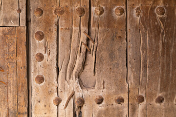 Close-up of an old wooden door, centuries old and medieval in appearance, in the small town of Ambel, in the Campo de Borja region, Zaragoza, Aragon, Spain.