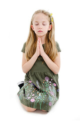 Praying little girl isolated on white background. Teenage girl praying on knees