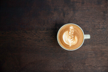 Coffee latte art top view on wood table