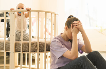 The mother is very tired, and the child does not want to fall asleep. Mom's trying to take a nap....