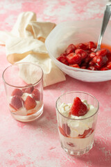 Whipped cream with strawberry on a pink background