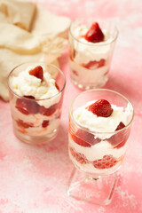 Whipped cream with strawberry on a pink background