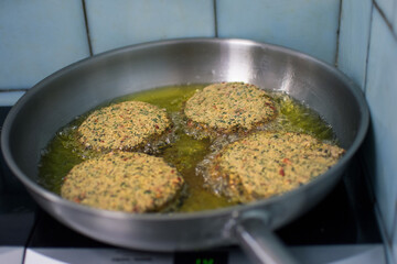 Closeup vegan patty grilling in frying pan for cooking vegetarian hamburgers