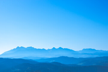 Obraz premium Blue surreal mountains against the backdrop of a cyan sky, fantastic fairytale mountain landscape