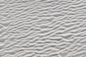 Fototapeta na wymiar Abstract background. Diagonal sand stripes texture made by sea waves on beach.