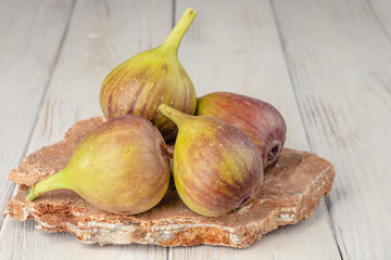 Fresh, light, healthy figs on white wooden background