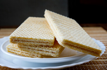 A few crisp waffles on a plate.