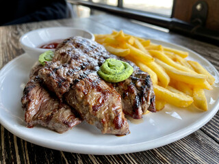 beef steak with fries and ketchup
