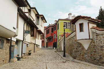 narrow empty street in the old town of Plovdiv, in Bulgaria, with a cobblestone and colorful houses in the sides
