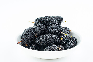 Mulberry on a plate on white background
