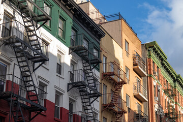 Row of Old Brick Buildings in Little Italy of New York City with Fire Escapes