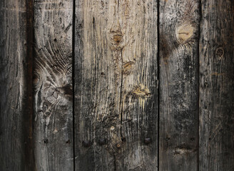 ancient, weathered and worn surface of dark wood from an old door or table - rough texture background