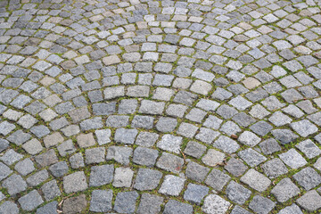 cobblestone with stone tiles in the floor of the street of an old town with the shape of arches - pattern for a historic background