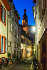 Apothekergasse (Pharmacist alley) and Heiliggeistkirche (Church of the Holy Spirit) at night, Heidelberg, Germany