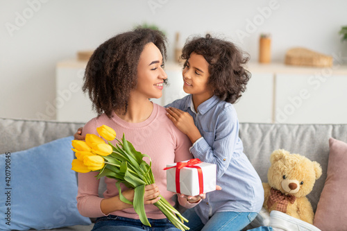 Black girl celebrating mother's day, greeting her mom