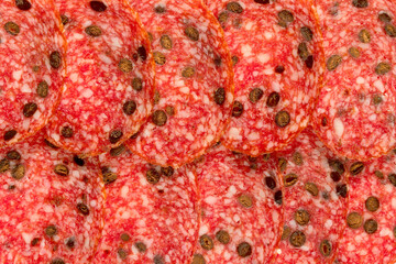 Slices of ham sausage as a natural background . Tasty salami slices ias a natural background . Smoked Sausage slices, as a natural background