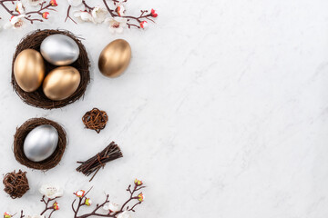 Design concept of Golden and silver Easter eggs in the nest with white plum flower.
