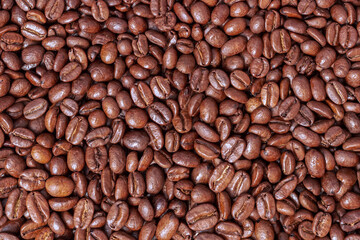 A scattering of roasted coffee beans close-up.