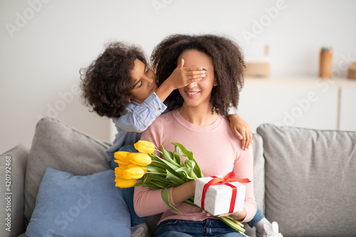 Black girl celebrating mother's day, greeting her mom