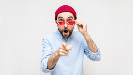 Shocked bearded film fan takes off his pixel glasses, portrait, white background, 16:9, copy space