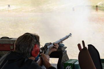 Vintage black powder rifles at a rifle range.