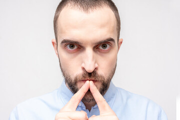 Serious thoughtful man stares intently at the camera, portrait, closeup