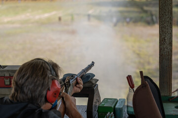 Vintage black powder rifles at a rifle range.