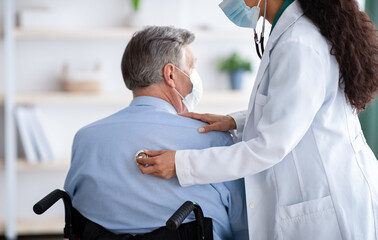 Senior male patient in wheelchair suffering from respiratory disease, having coronavirus, medical...