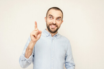 Bearded pointing finger up, man has a brilliant idea, white background, copy space