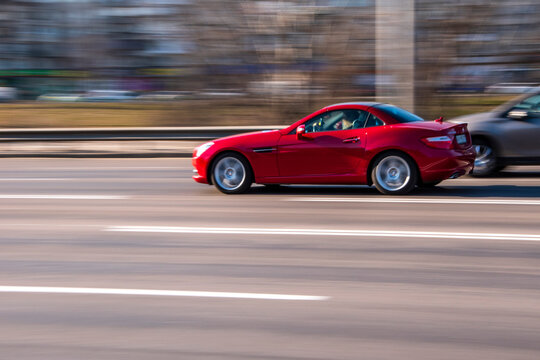 Ukraine, Kyiv - 11 March 2021: Red Mercedes-Benz SLK250 car moving on the street;