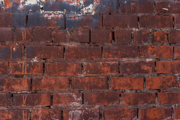 Aged red brick wall texture with traces of paint
