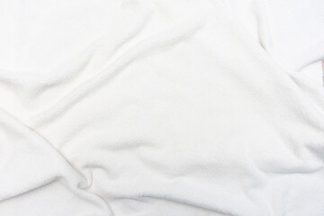 Obraz premium Imitation of a snow-covered surface, white crumpled plaid, background with copy space, top view