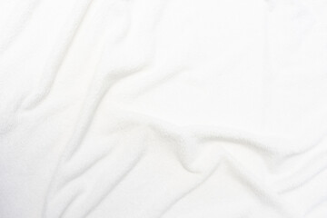 Imitation of a snow-covered surface, white crumpled plaid, background with copy space, top view