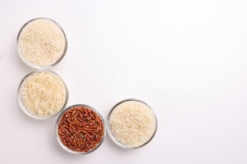 Long grain basmati medium grain jasmine short grain pilaf polau risotto brown low glycaemic index gi rice in small glass bowl on white background copy text space top flat lay view border frame