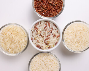 Long grain basmati medium grain jasmine short grain pilaf polau risotto brown low glycaemic index gi rice in small glass bowl on white background copy text space top flat lay view
