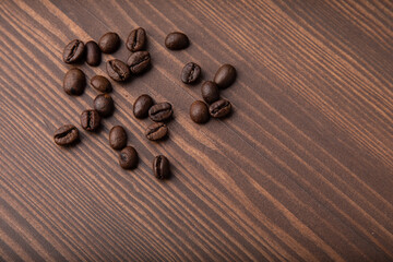 Roasted coffee beans on a wooden background.Top view