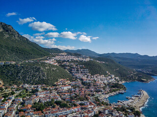 The top view from the drone of Kas resorts and city with amazing blue and clear lagoon and yachts in Mugla province of Turkey