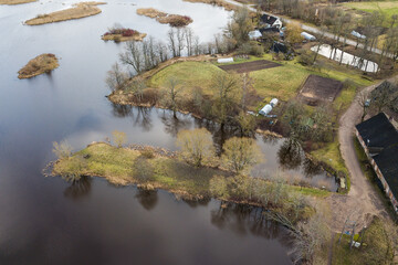 Fototapeta na wymiar Aerial view of water mill pond, islands and peninsulas in Ezere, Latvia