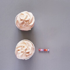Milky cream cupcake. Birthday sweet bakery. Cookies. Yummy buttercream dessert. Wedding party food. Grey background. Holiday recipe. Anniversary gourmet quote. Two pieces