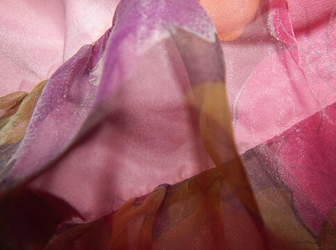 Background with close up of shiny fabrics in pink and purple