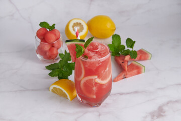 Fresh fruit smoothies, Homemade watermelon lemonade, portrait of summer fresh fruit drink. fruit flavored water mix with lemon, watermelon, mint leaves and ice. detox water cocktail, selective focus.