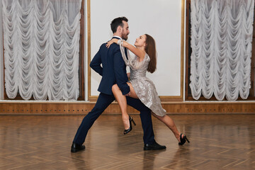 dance training, man and woman practice tango elements in the ballroom