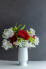 White vase with red and white flowers
