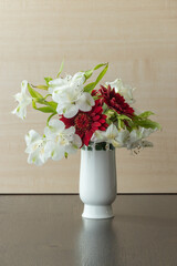 White vase with red and white flowers