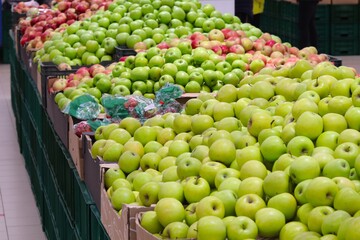 Fresh apples in assortment on pallets in a supermarket 