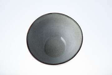 Empty beautiful handmade ceramic bowl isolated on white background. Close-up