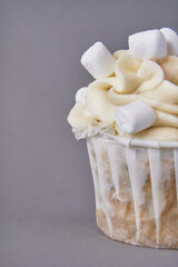 Milky cream cupcake. Birthday sweet bakery. Cookies. Yummy buttercream dessert. Wedding party food. Grey background. Holiday recipe. Anniversary gourmet. One pieces. Marshmallow