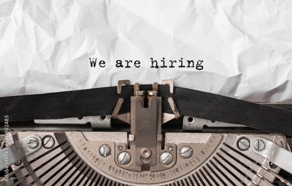 Poster text we are hiring typed on retro typewriter